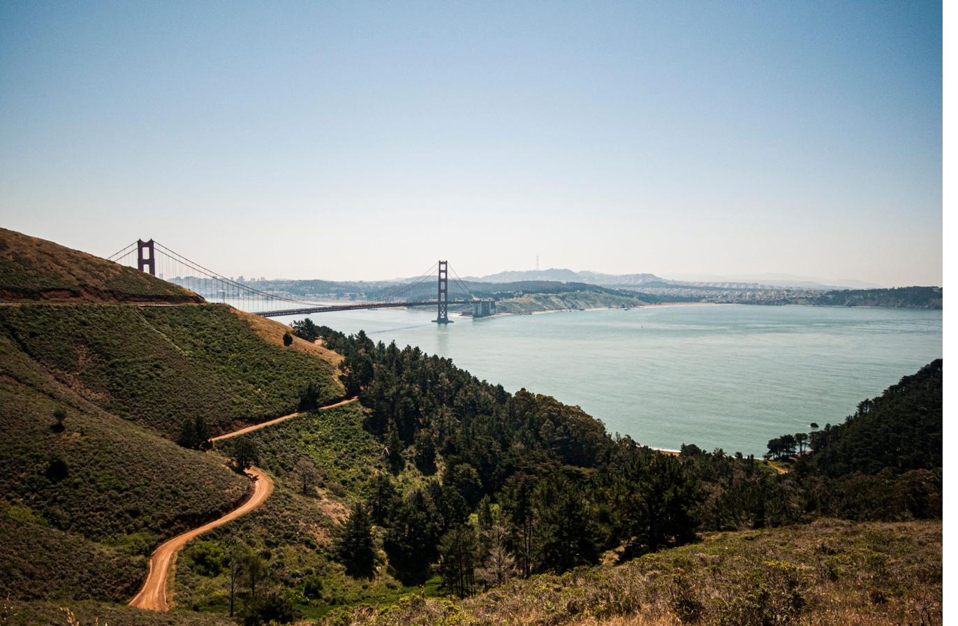 Golden hills and open water seen from a high coastal vista